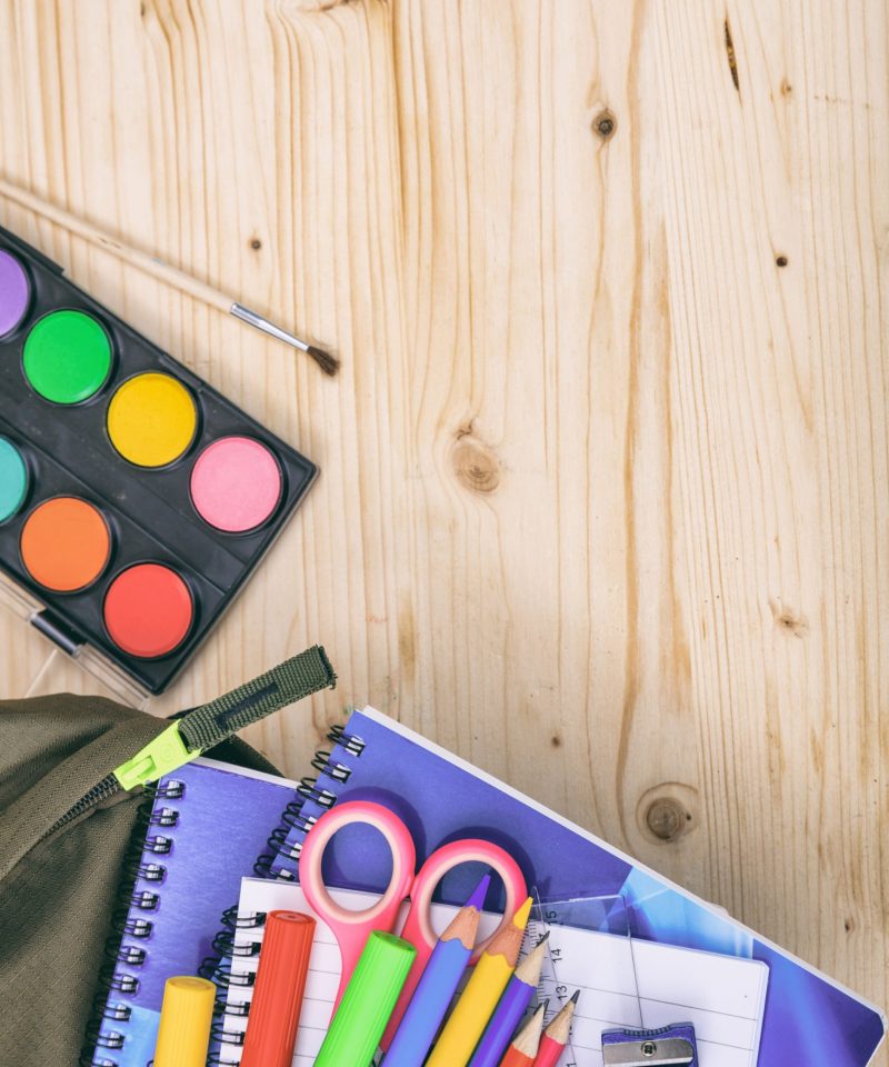 Back to school concept. School supplies on wood background, top view. Kid creative and education concept.